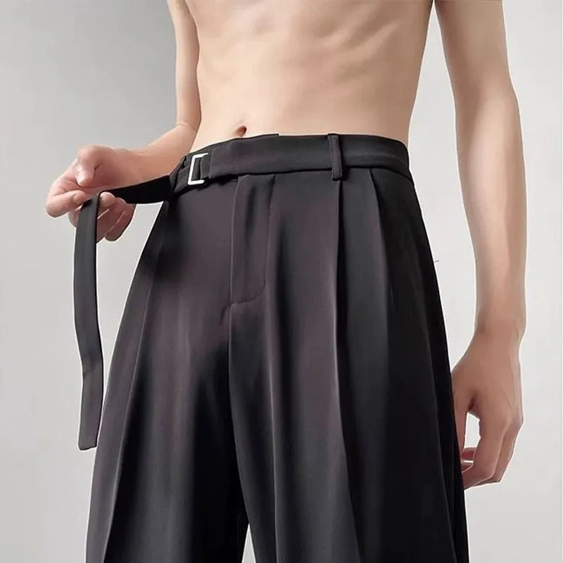 Black thin straight wide leg trousers on a hanger, showing loose fit and straight leg opening.