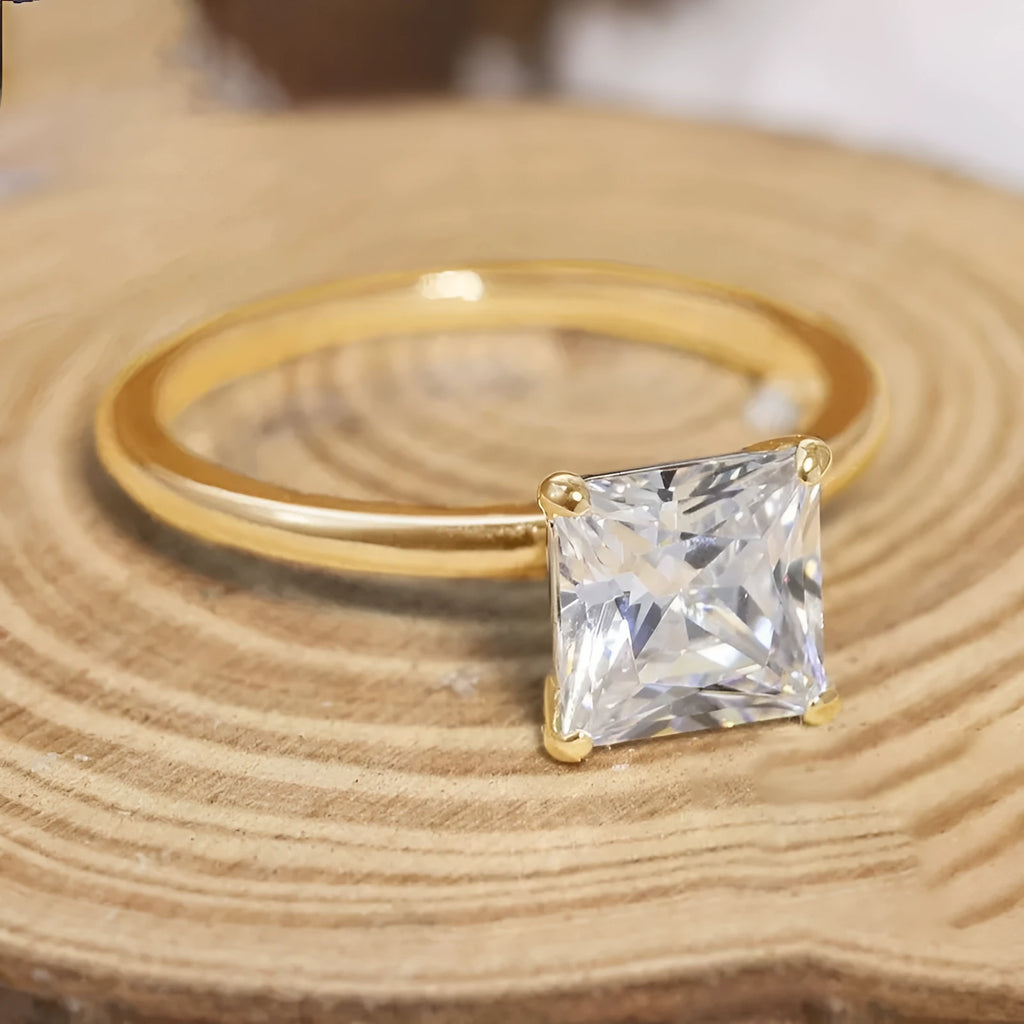 Simple geometric 925 silver ring in silver, gold, and rose gold colours on a plain background.