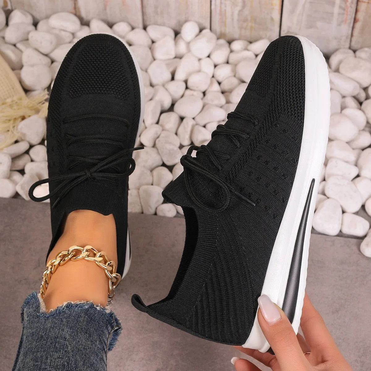 Women's low-top red fly-knit sneakers with round toe and white injection moulded sole on a light background.
