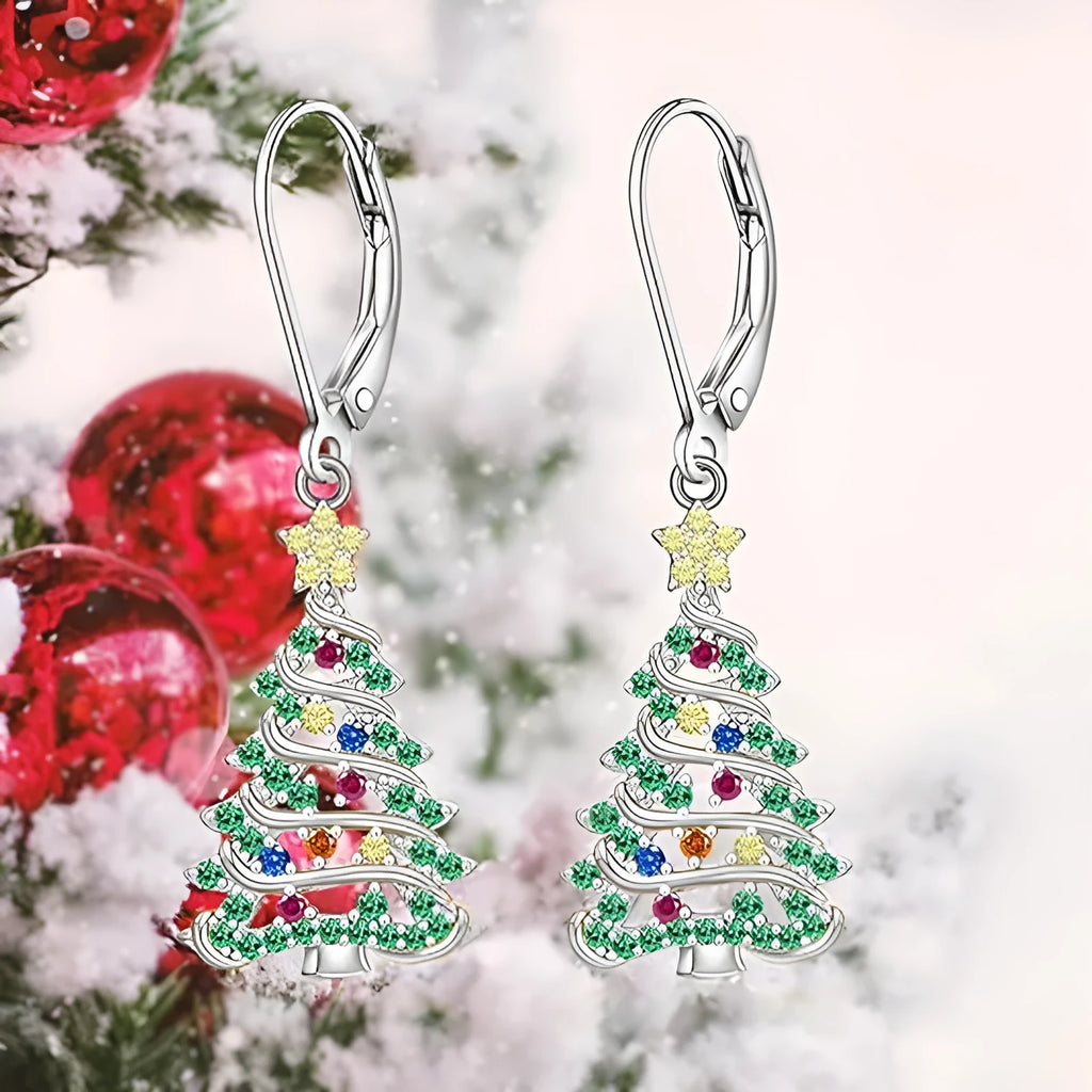 A pair of star-shaped copper earrings with a Christmas tree design, plated in a white gold colour.