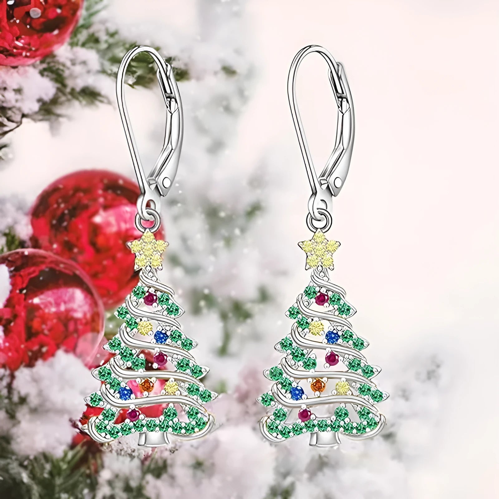 A pair of star-shaped copper earrings with a Christmas tree design, plated in a white gold colour.