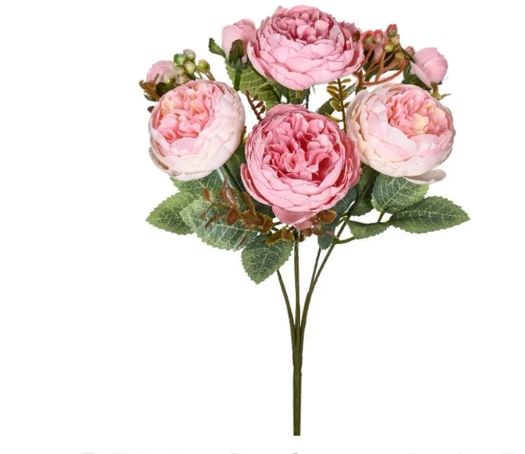 Silk artificial peony bouquet in champagne colour on a table.