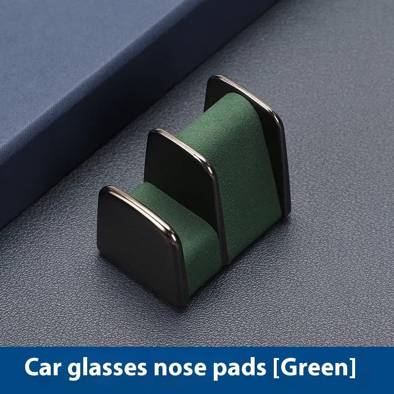 Green zinc alloy and leather glasses clip holder mounted on a car dashboard.