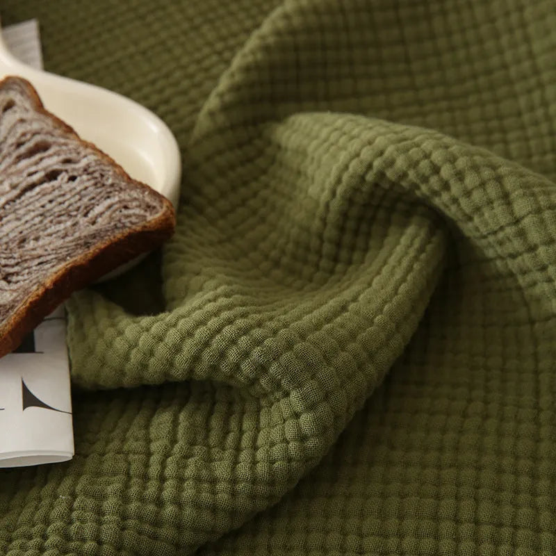 Four-layer gauze cotton blanket with tassel detailing in avocado green colour