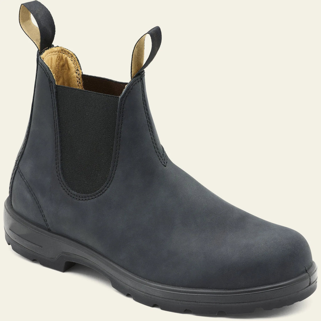 Vintage frosted brown leather Chelsea boot with round toe and low heel on a wooden surface.
