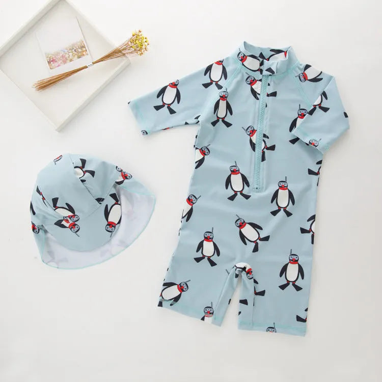 Boys' penguin print long sleeve swim top and matching swimming cap set on a hanger.