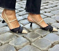 Apricot and black colour block women's stiletto sandals with a buckle strap and pointed toe.