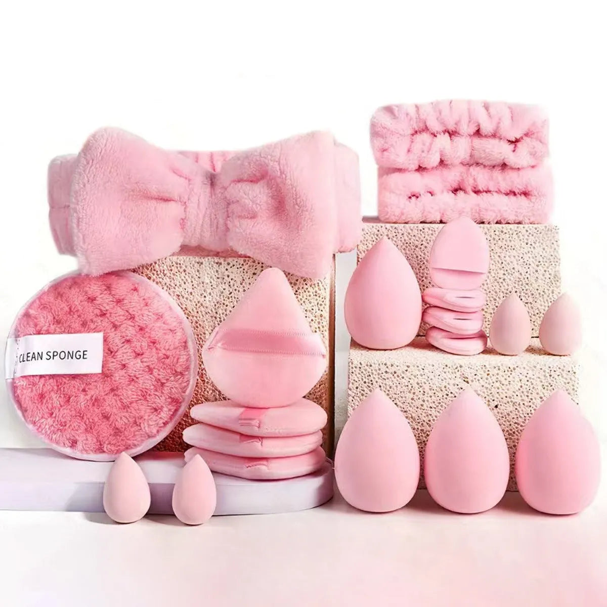 Beauty tool combination set with multiple pieces in pink, brown and purple colours for face wash and makeup application