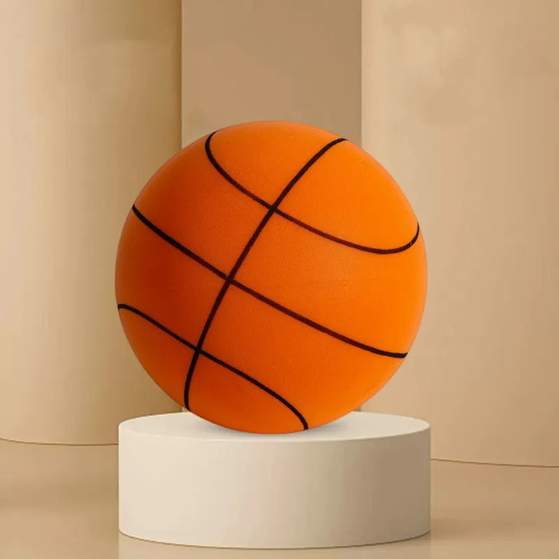 Silent high density foam sports ball in assorted bright colours next to a basketball frame.