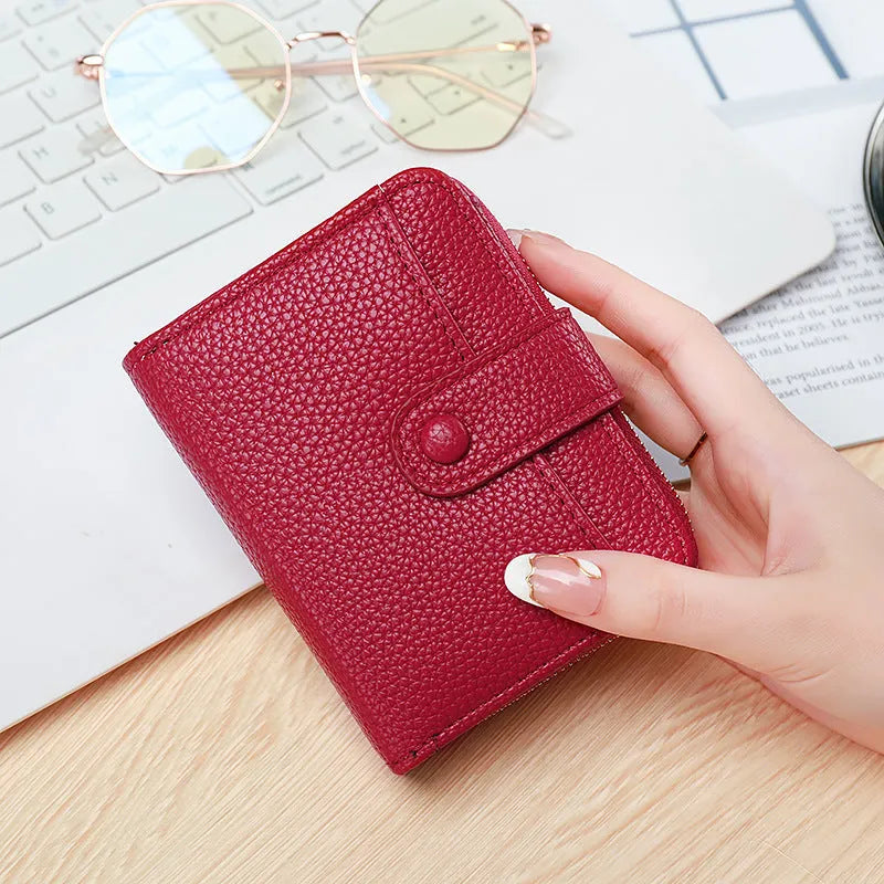 Ladies' short two-fold wallet in PU leather with a lychee pattern, shown in beige, pink, black, and red.