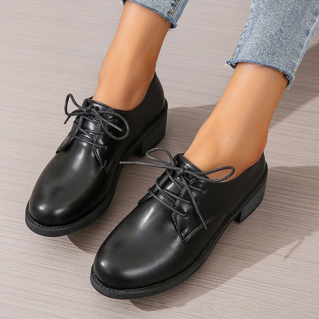 Black women's low-top work shoes with a chunky mid-heel and rounded toe.