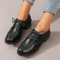 Black women's low-top work shoes with a chunky mid-heel and rounded toe.