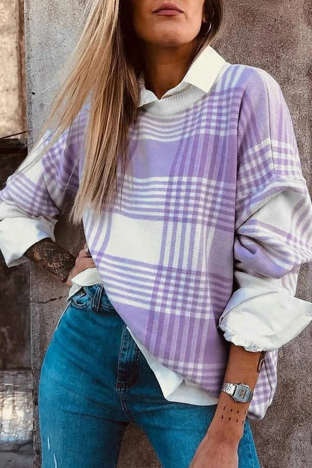 Lilac plaid print loose fit long sleeve sweater with ribbed cuffs on a hanger.
