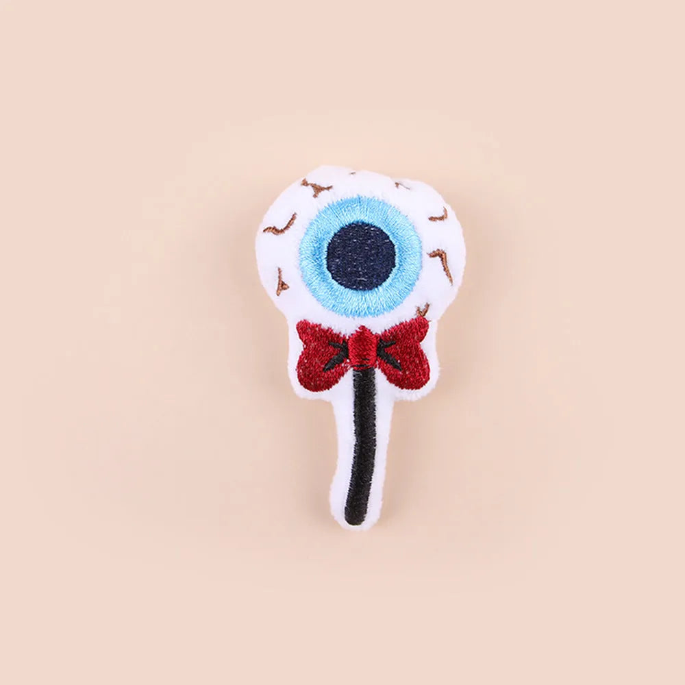 Small plush cat teaser toy with candy and skull designs in eyes or candy colours