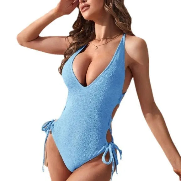 Women's black hollow backless tether one-piece swimsuit on a mannequin, showing sleeveless design and solid colour.