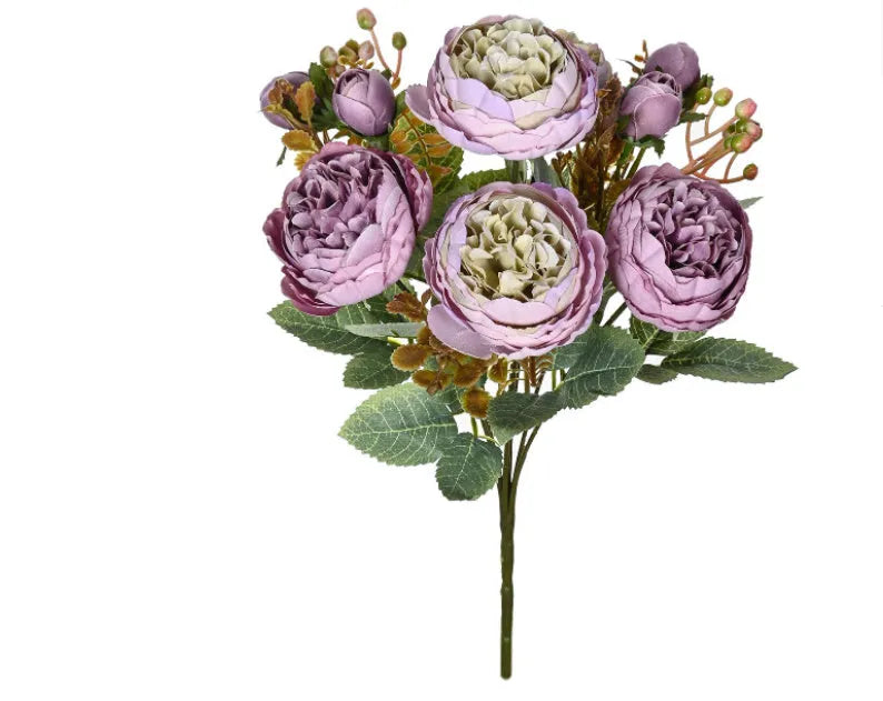 Silk artificial peony bouquet in champagne colour on a table.