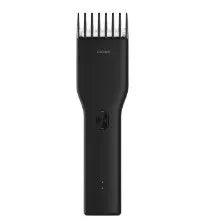 Black and white cordless electric hair clipper with ceramic cutter head and adjustable comb.