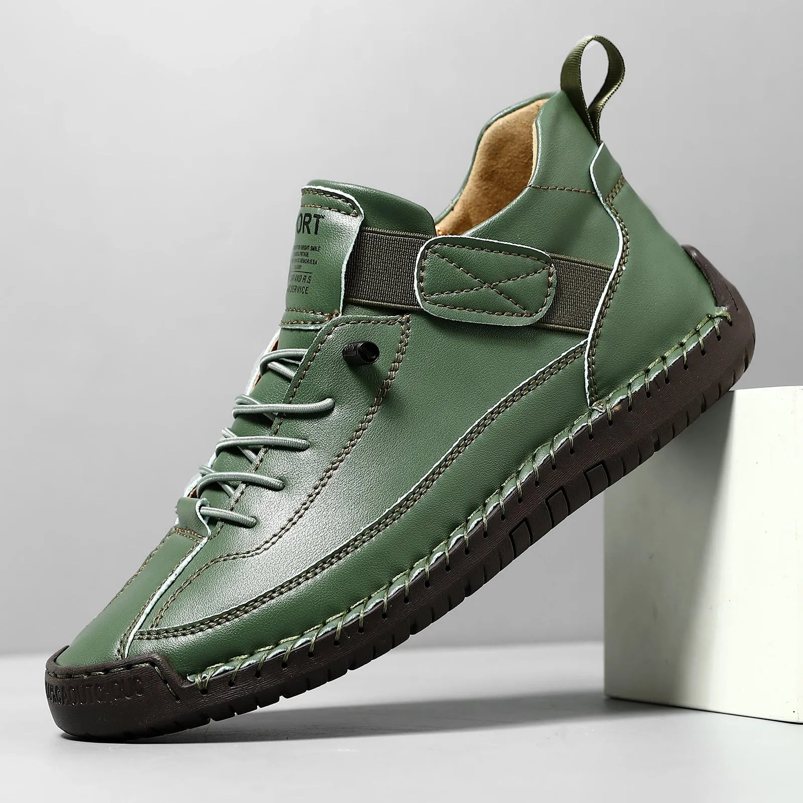 Men's mid-top Martin boot in khaki colour with tooling stitching on the rubber sole.