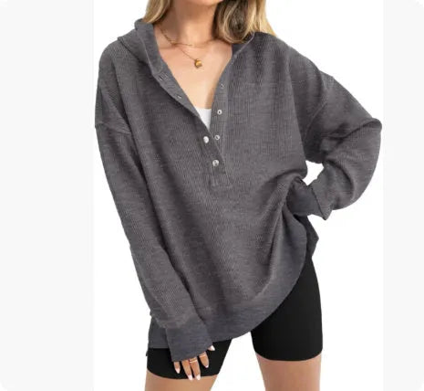 Women's loose raglan sleeve pullover sweater in peacock green colour, laid flat.