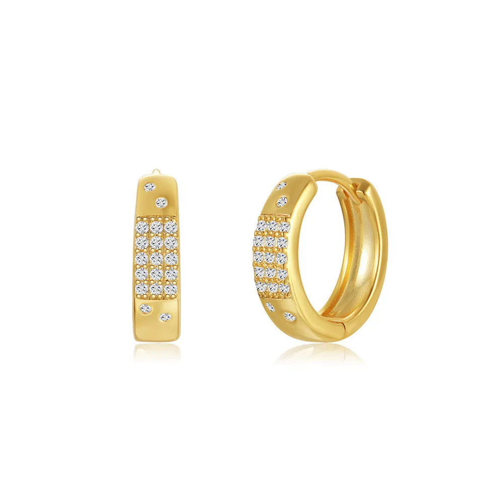 A pair of simple geometric brass earclip earrings with a round element and electroplated golden finish.