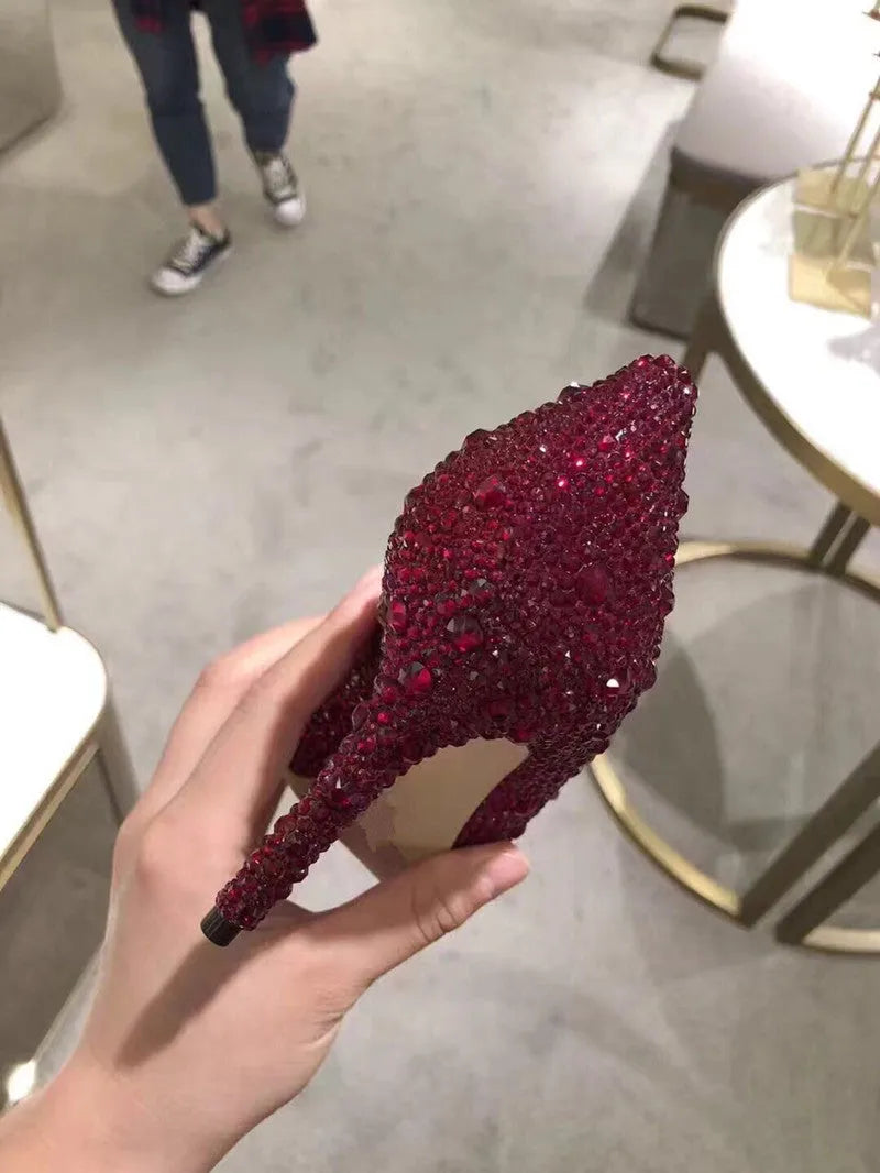 Women's gold high heels with pointed toes, rhinestone decoration, and stiletto heel