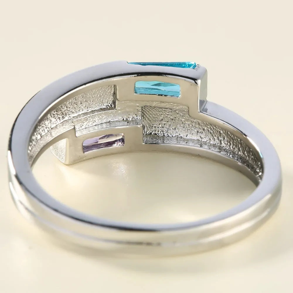 Silver electroplated copper ring with inlaid zircon details on a hand