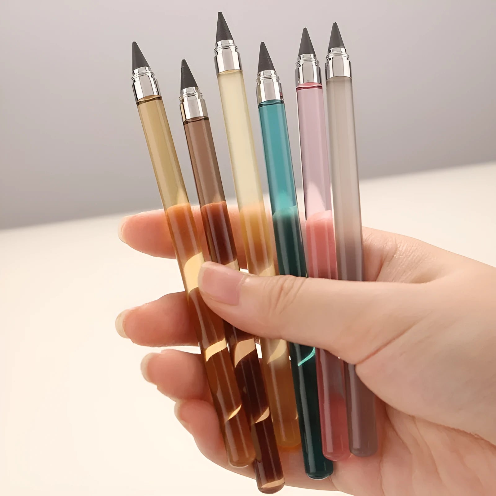 Acrylic transparent sharpening-free pencil with alloy pen head showing coloured refills