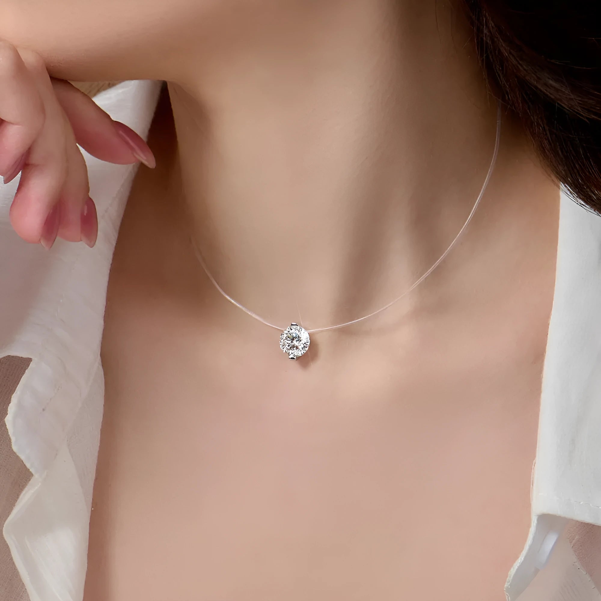 Women's silver clavicle chain necklace with a floating moissanite stone and plum blossom detail.