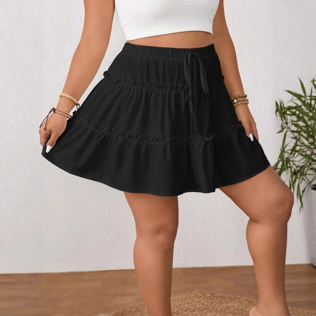 White A-line pleated skirt with adjustable lace-up detail on a mannequin.