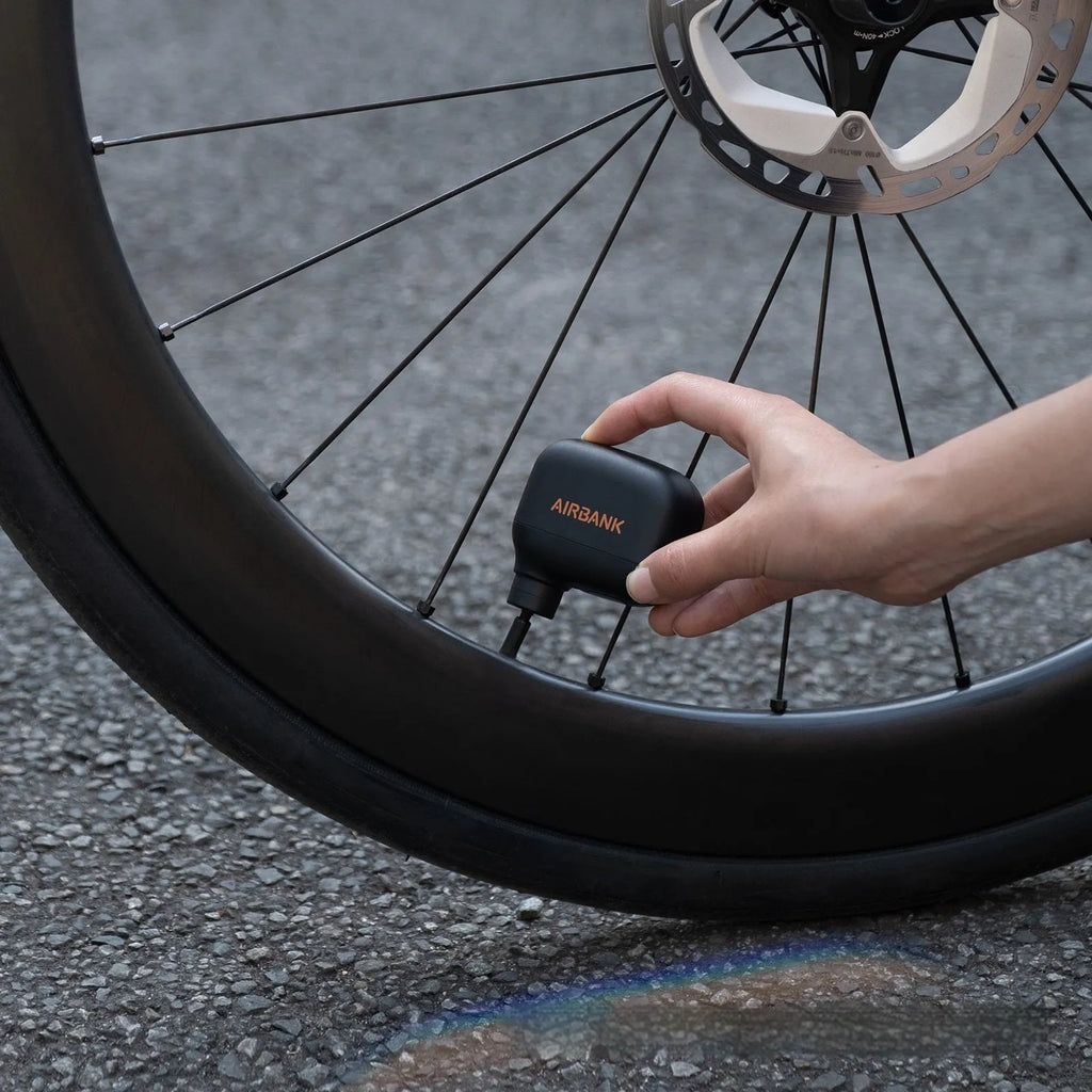 Black AS100 electric bicycle tyre pump with USB charging cable and waterproof bag