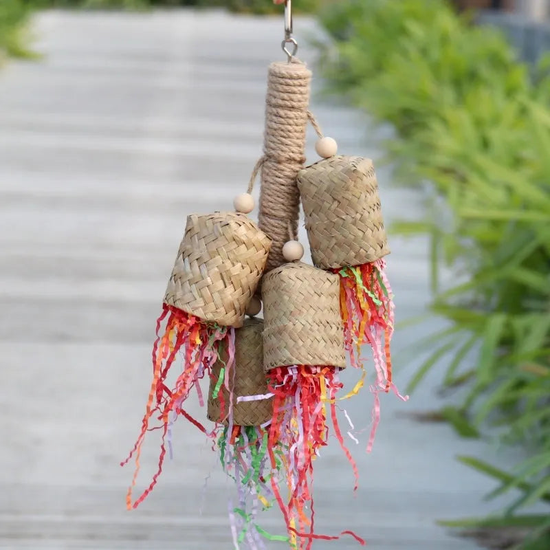 Wooden parrot chew toy with colourful shredded paper hanging from sisal rope