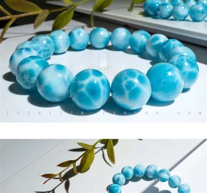 Blue natural Bodhi seed and crystal sea-pattern stone bracelet with a single pearl accent on a wrist.