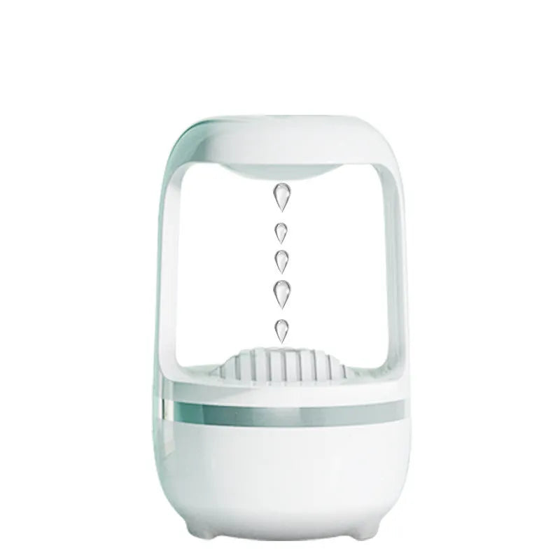Black or white anti-gravity humidifier with water droplet effect on a desk.