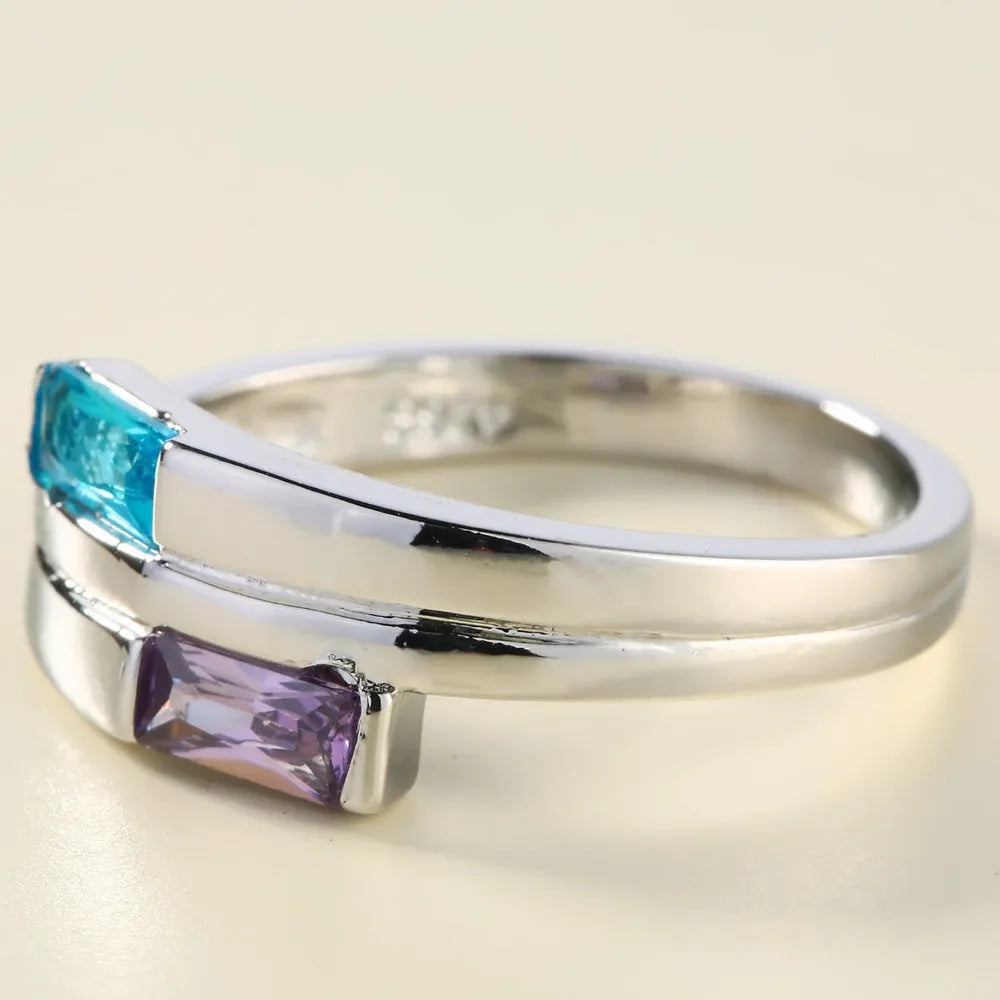 Silver electroplated copper ring with inlaid zircon details on a hand