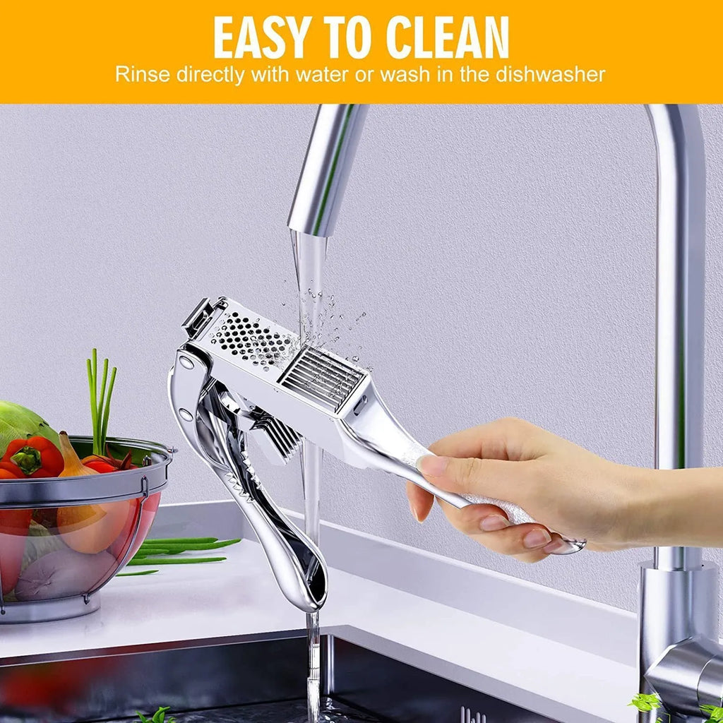 Two-in-one aluminium alloy garlic press with silicone peeler cleaning brush on a kitchen surface