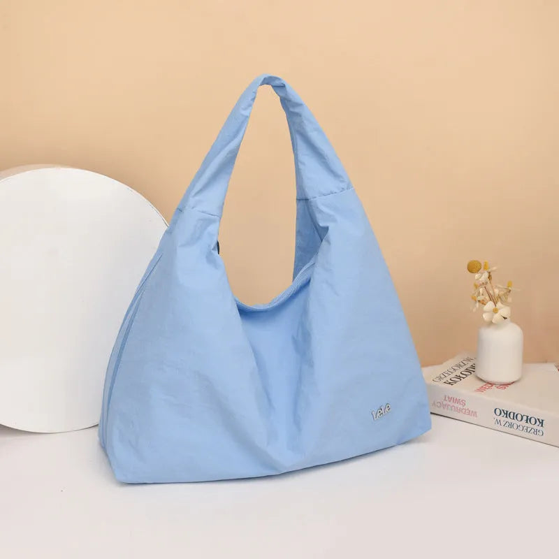 Heart-shaped soft nylon crossbody bag for women in black, blue, khaki, or yellow.