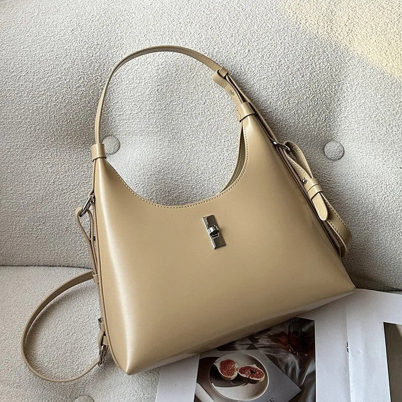A soft genuine leather dumpling-shaped crossbody shoulder bag in a street style, shown with internal phone pocket.