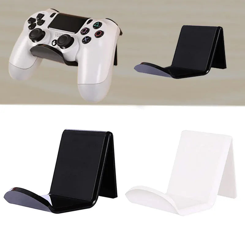 A universal plastic wall mount bracket for game controllers, shown in black, white, and transparent colour options.
