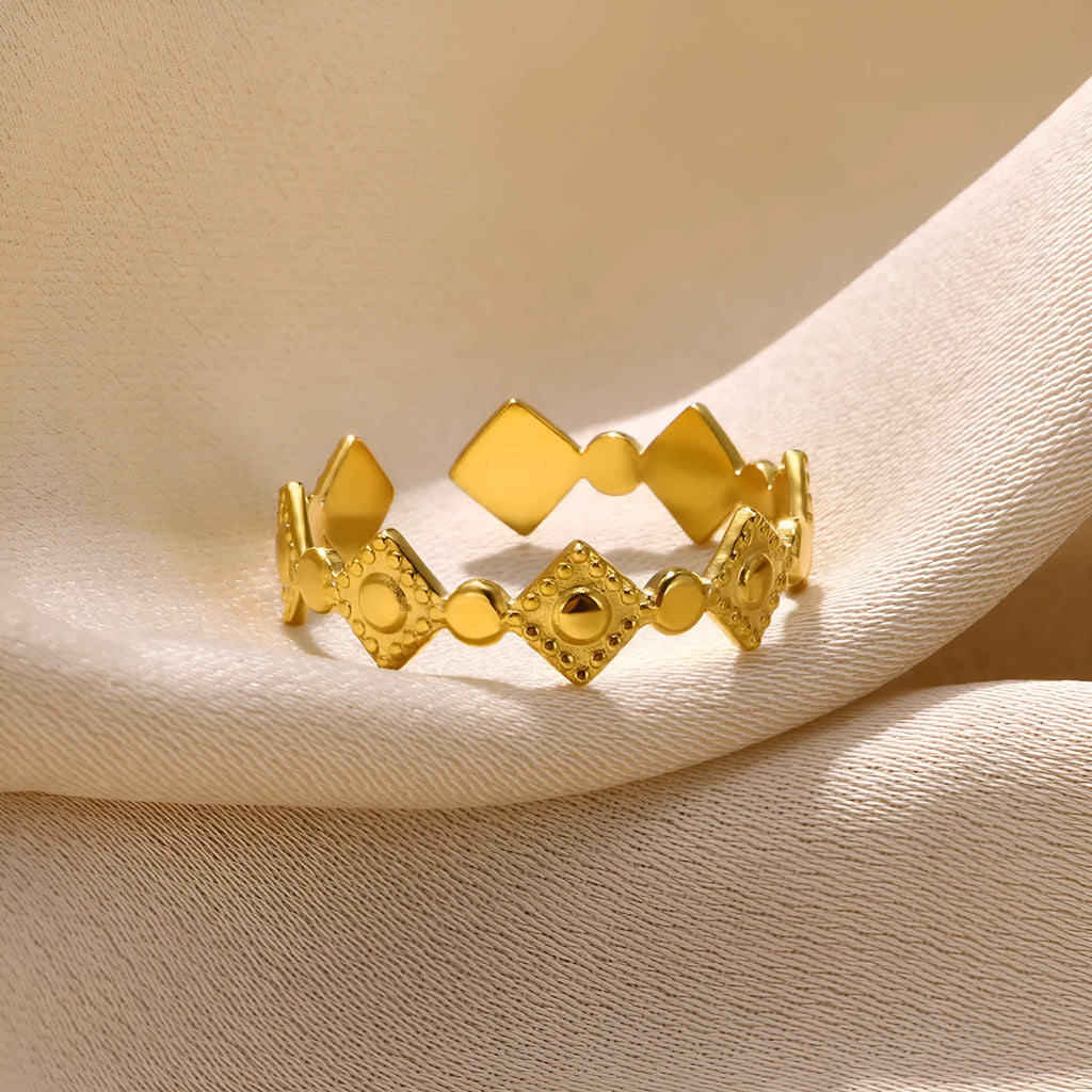 Gold diamond geometric titanium steel women's ring on a finger.