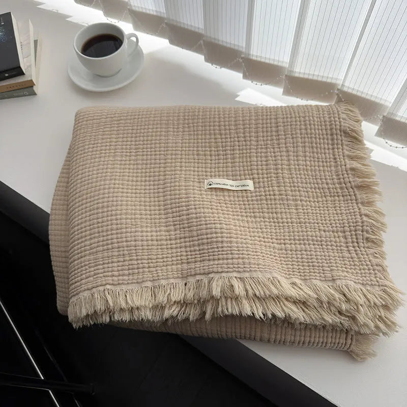 Four-layer gauze cotton blanket with tassel detailing in avocado green colour