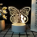 White heart-shaped acrylic table lamp with touch control on a wooden surface.