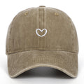 Soft cotton baseball cap with an embroidered red love heart on the front, shown in adjustable size.
