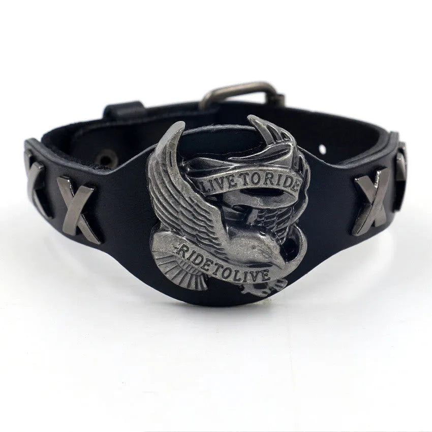 Black geometric leather bracelet with a detailed eagle watch-button clasp, shown flat.