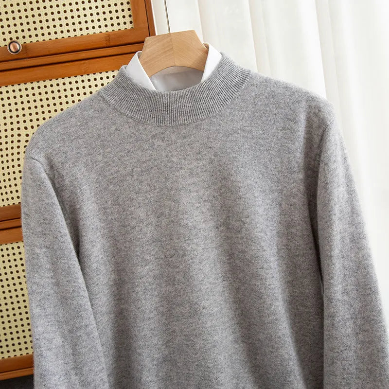 Man wearing a loose-fit half-collar wool sweater in a dark colour, showcasing the knitted texture and neckline design.