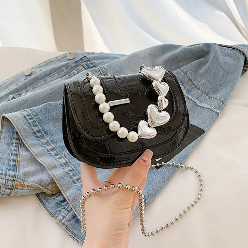 Laser pearl effect mini saddle tote handbag in horizontal square shape with crossbody strap