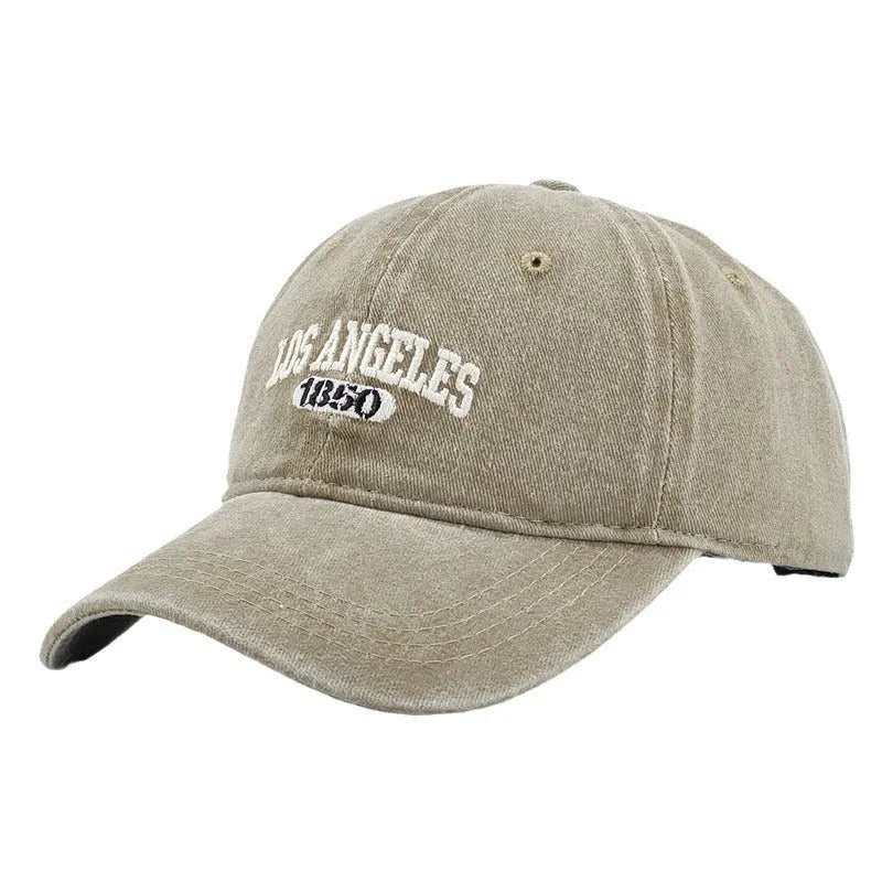 Retro peaked cap with distressed letter embroidery and adjustable sizing in conical crown design