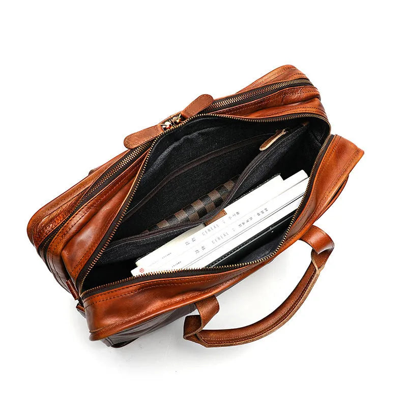 Men's vintage leather briefcase in black showing internal organisation pockets and 42cm width