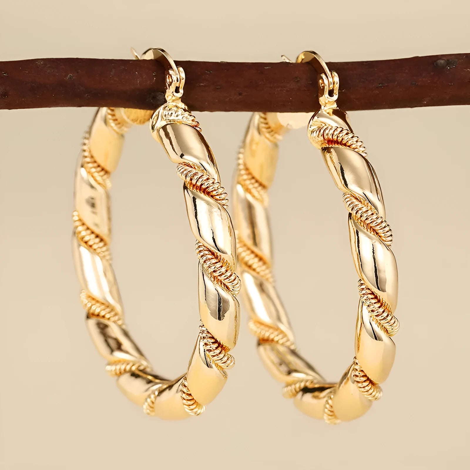 Geometric copper earrings with gold tone finish showing ring and line design elements