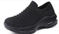 Women's plus size fly-knit socks shoes in dark blue with mesh upper and low heel, showing round toe design.