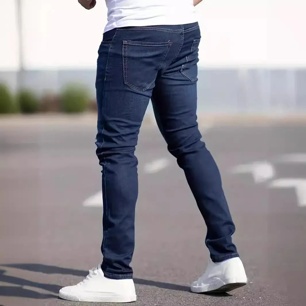Men's dark blue slim-fit skinny casual jeans on a neutral background
